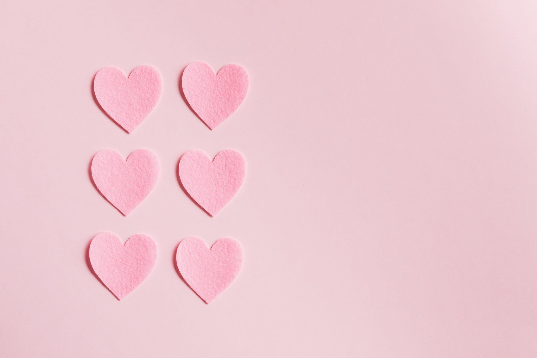 pink paper hearts on light pink surface