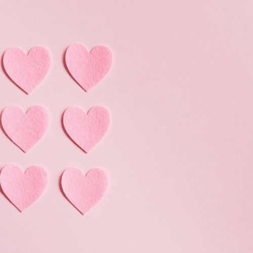 pink paper hearts on light pink surface